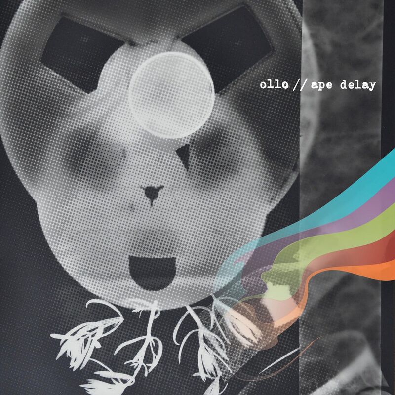 Black-and-white album art of a ghostly face with rainbow streaks.