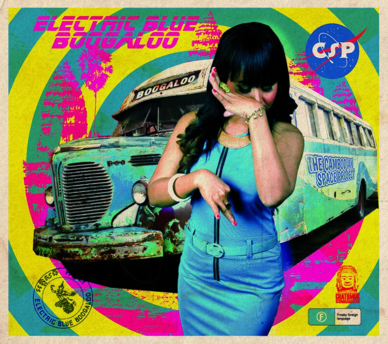 Album cover in pink, yellow and teal: a woman in a blue dress posing in front of an old green bus, with the title in pink lettering.