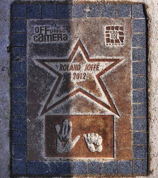 A stone plaque with a star bearing his name and the year 2012, and two handprints below.