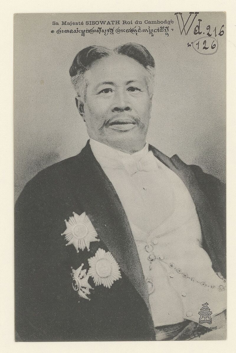 A black and white portrait of an older man with swept-back gray hair, in a dark coat with decorations on his chest.